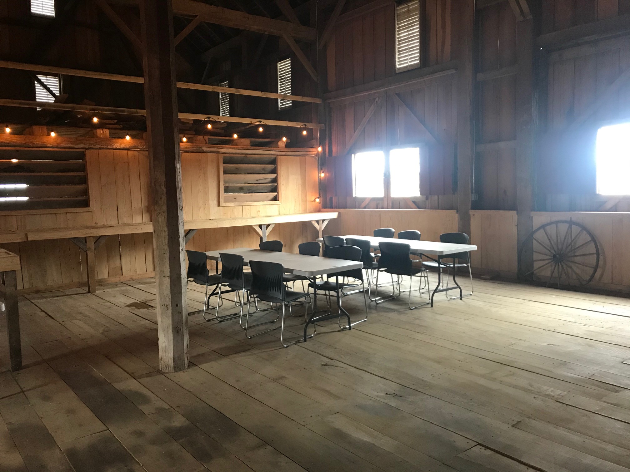 tables and chairs set-up inside creek bend farm barn